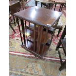 Mahogany revolving bookcase with interesting brass plaque