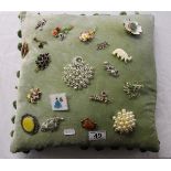 Collection of vintage brooches on cushion