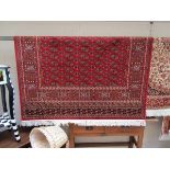 Red ground Bokhara carpet (approx 2.3m x 1.6m)