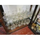 2 shelves of glass decanters to include early examples