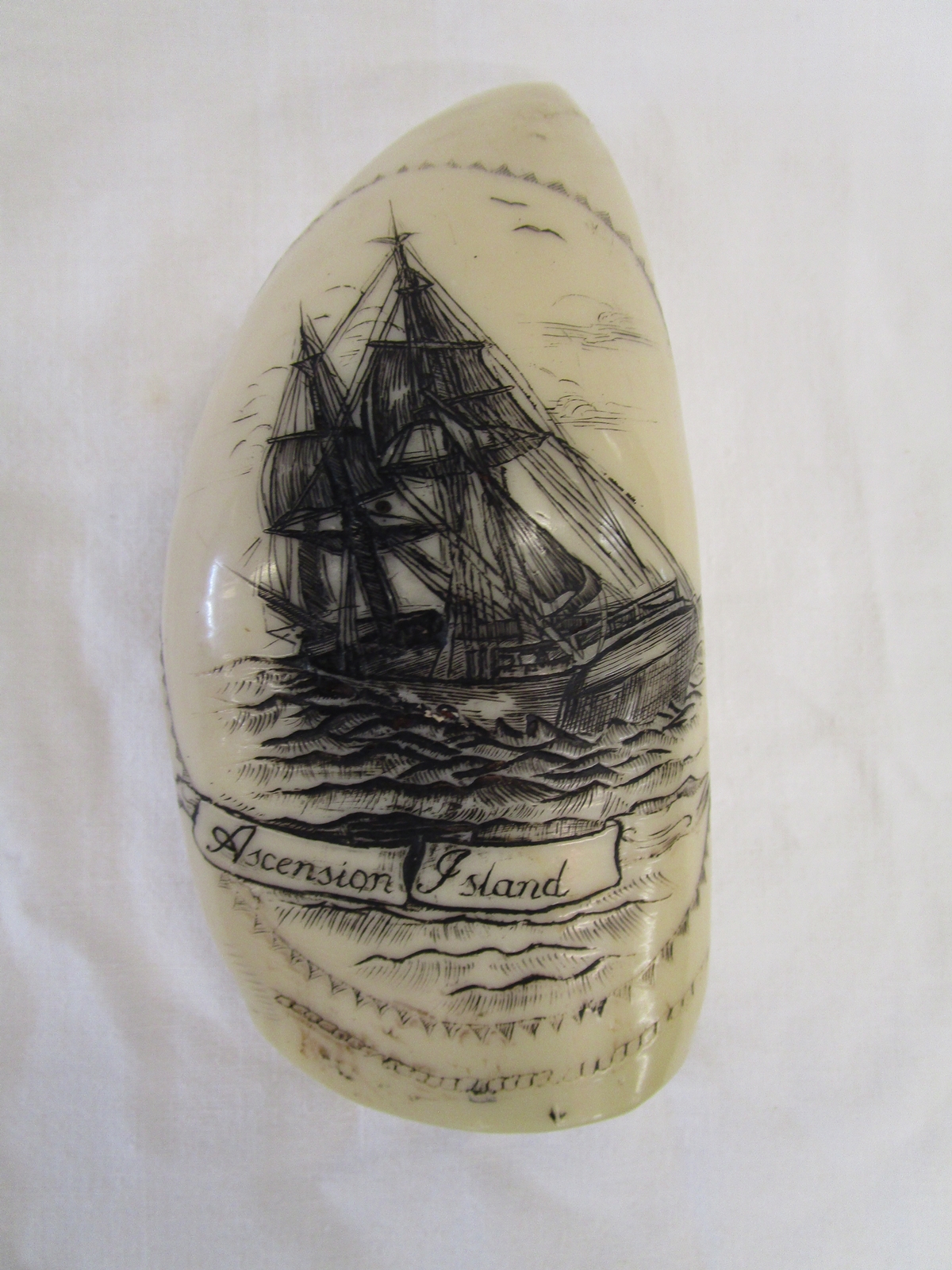 Reproduction of a scrimshaw work whale tooth