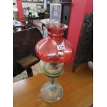 Oil lamp with cranberry glass shade