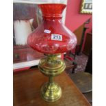 Brass oil lamp with cranberry coloured shade - By Duplex