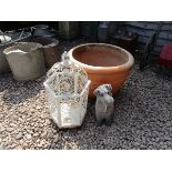 Stone dog figure, painted metal bird cage and large terracotta planter