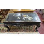 Oriental black lacquered coffee table with decorative inset top