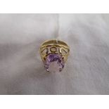 Gold ring set with a large amethyst