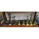 Shelf of brass & treen candlesticks