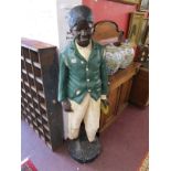 Life size Blackamoor style figure of boy in worn clothes