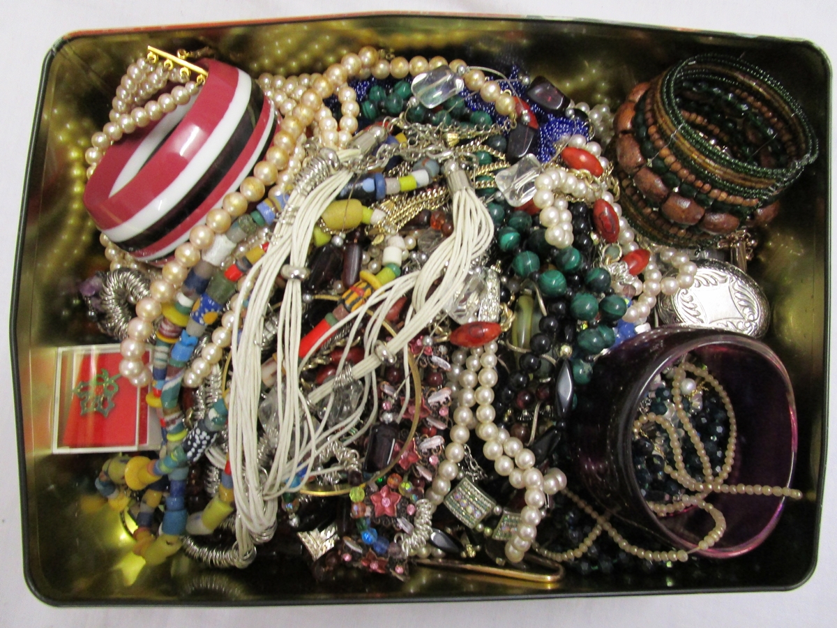 Tin of costume jewellery