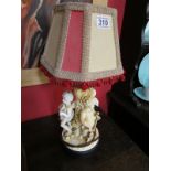 Table lamp adorned with 3 cherubs