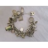 Silver charm bracelet with many charms