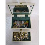 Musical jewellery box containing badges