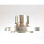 A 1970's spun aluminium ceiling light with two tiers and a red partially enamelled interior