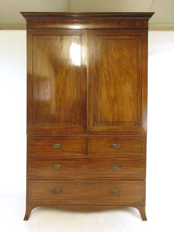 An early 19th century mahogany and ebony strung linen press,