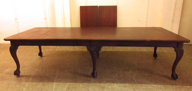 an early 20th century mahogany extending dining table with wind out mechanism on cabriole legs with