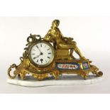 A 19th century French ormolu mantle clock surmounted by a lounging youth over painted ceramic