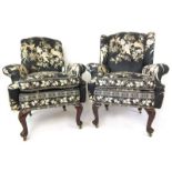 A 'his and hers' pair of early 20th century mahogany arm chairs in the early 18th century style,