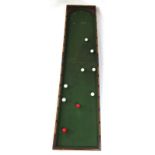 A 19th century mahogany folding bagatelle board with baize lined interior,