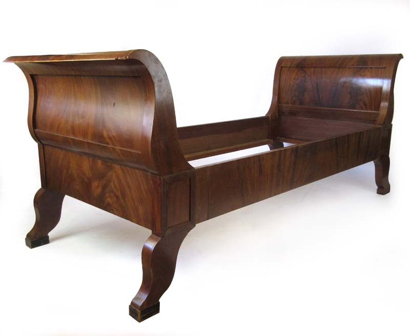 An early 20th century flame mahogany Biedermeier style single bed, h. 92 cm, l. 215 cm, d.