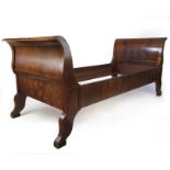 An early 20th century flame mahogany Biedermeier style single bed, h. 92 cm, l. 215 cm, d.