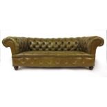 A Edwardian walnut Chesterfield sofa upholstered in olive green leather, h. 64 cm, w. 184 cm, d.