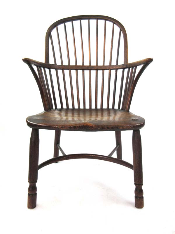 A 19th century oak and elm comb back Windsor chair with turned front legs and stretchers, h.