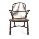 A 19th century oak and elm comb back Windsor chair with turned front legs and stretchers, h.
