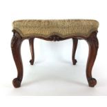 A late 18th century mahogany stool with needle work upholstery on cabriole legs with carved knees,