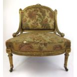 A late 18th century giltwood bedroom chair upholstered in a floral silk fabric with swag,