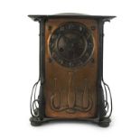 A 1930's Liberty's style embossed copper mantle clock by John Kendrick of Birmingham, h. 35 cm, w.