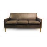 A black three seater reception-type sofa on aluminium feet