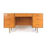 A 1960's oak utility-type dressing table with an arrangement of seven drawers, w.