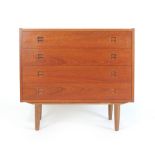 A 1960/70's Danish teak chest of four long drawers with integral turned handles on tapering legs by