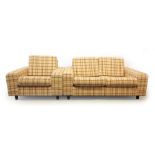 A 1970's striped cloth two seater sofa together with a matching armchair on mahogany feet