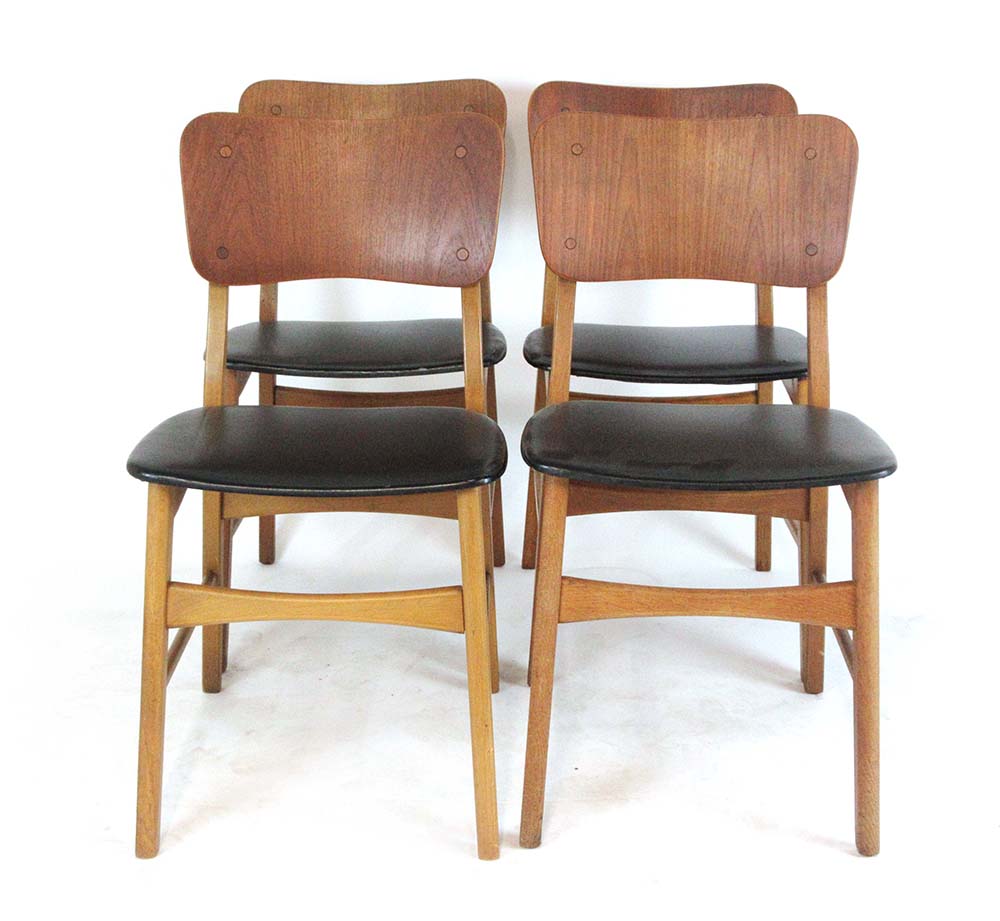 A set of four 1960's 'butterfly' type dining chairs with bent ply backs over vinyl seats