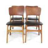 A set of four 1960's 'butterfly' type dining chairs with bent ply backs over vinyl seats