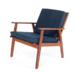 A 1960/70's low armchair with a teak frame and loose blue cushions,