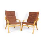 A pair of 1970's Stouby lounge armchairs with bentwood frames and brown leather upholstery