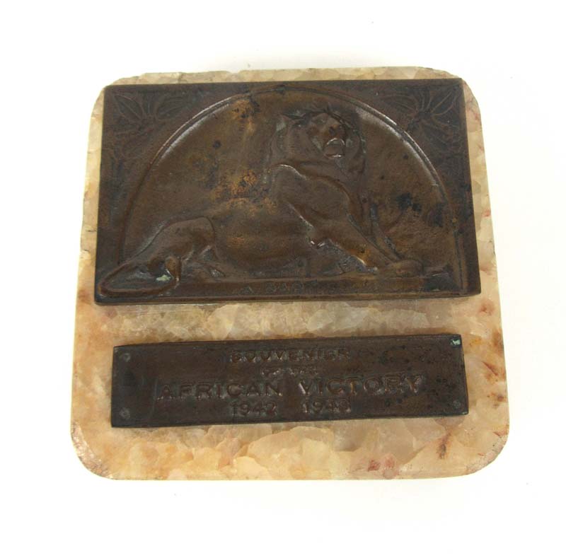 A bronze and stone plaque or ashtray being a 'Souvenier of the African Victory 1942 1943'. L. 11 cm.