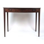 A late 18th century mahogany bow front writing table,
