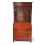 A George III and later mahogany bureau bookcase, the top with two astragal glazed doors over the