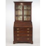 A late 18th century mahogany bureau bookcase, the cavetto cornice over two astragal glazed doors,