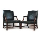 A near pair of early 20th century mahogany Gainsborough chairs upholstered in green leather with