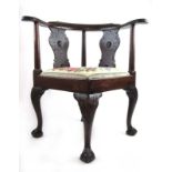 A late 19th century mahogany corner chair with a needle work upholstered drop in seat,