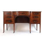 An Edwardian mahogany, satinwood banded and boxwood strung bow front desk,