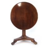 A Regency and later mahogany tilt top table, the circular top on tapering hexagonal column,