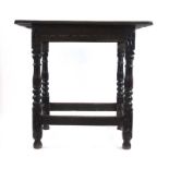 An early 18th century oak table, the cleated top over a carved frieze on turned legs, h. 74 cm, w.