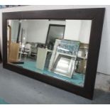 WALL MIRROR, or large proportions, dark wood frame, bevelled plate, 110cm x 240cm.