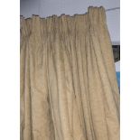 CURTAINS, a pair, lined and interlined in gold woven fabric, each 230cm gathered by 246cm dropped.