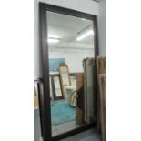 WALL MIRROR, of very large proportions, dark wood frame, bevelled plate, 130cm x 250cm H.